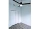 Bright bedroom features a ceiling fan and a closet with bifold doors at 7147 Yacht Basin Ave # 119, Orlando, FL 32835