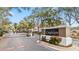 Crestview community entrance featuring a large sign, gated access, manicured landscaping, and mature trees at 7147 Yacht Basin Ave # 119, Orlando, FL 32835