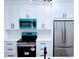 Modern kitchen with white cabinets, stainless steel appliances, quartz countertops, and stylish backsplash at 7147 Yacht Basin Ave # 119, Orlando, FL 32835