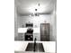 Bright kitchen featuring modern white cabinets, stainless steel appliances and black hardware at 7147 Yacht Basin Ave # 119, Orlando, FL 32835