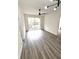 A bright living room with modern light fixture, ceiling fan, and sliding glass doors at 7147 Yacht Basin Ave # 119, Orlando, FL 32835