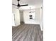 Bright, open-concept living room showcasing a modern light fixture and view to the kitchen at 7147 Yacht Basin Ave # 119, Orlando, FL 32835