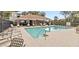 Community pool surrounded by lounge chairs at 7147 Yacht Basin Ave # 119, Orlando, FL 32835