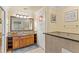 Elegant bathroom highlighting granite countertops, custom cabinetry, and a well-lit mirror for added convenience at 7630 Heritage Crossing Way # 302, Reunion, FL 34747