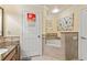 Bright bathroom featuring a soaking tub with tile surround and granite vanity with decorative fixtures at 7630 Heritage Crossing Way # 302, Reunion, FL 34747
