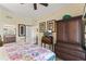Inviting bedroom showcasing wood floors, a cozy bed, and elegant decor elements throughout the space at 7630 Heritage Crossing Way # 302, Reunion, FL 34747