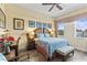 Cozy bedroom with a ceiling fan, neutral walls, and a patterned blue bedspread at 7630 Heritage Crossing Way # 302, Reunion, FL 34747