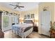 Comfortable bedroom with hardwood floors and a relaxing balcony, providing a cozy space to unwind at 7630 Heritage Crossing Way # 302, Reunion, FL 34747