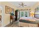 Serene bedroom featuring wood floors, a comfy bed, and a private balcony, creating a relaxing retreat at 7630 Heritage Crossing Way # 302, Reunion, FL 34747