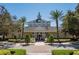 Elegant community center with manicured landscaping and palm trees, providing a welcoming space for gatherings and events at 7630 Heritage Crossing Way # 302, Reunion, FL 34747