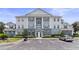 Attractive condo building with convenient parking, complemented by manicured landscaping and easy access to community amenities at 7630 Heritage Crossing Way # 302, Reunion, FL 34747