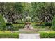 Beautiful central fountain with decorative landscaping and walking paths, enhancing the community's appeal at 7630 Heritage Crossing Way # 302, Reunion, FL 34747