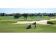 Lush golf course view with sand traps, ponds, and manicured greens, offering a picturesque and challenging playing experience at 7630 Heritage Crossing Way # 302, Reunion, FL 34747
