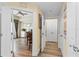 Welcoming hallway with wood-look floors offering views into the living room at 7630 Heritage Crossing Way # 302, Reunion, FL 34747