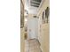 Hallway featuring laundry closet, tile flooring, neutral walls, and contemporary wall decor at 7630 Heritage Crossing Way # 302, Reunion, FL 34747