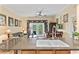 Open kitchen and dining area with large sink and seating bar overlooking a living area at 7630 Heritage Crossing Way # 302, Reunion, FL 34747
