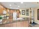 Open concept kitchen with granite countertops, wood cabinets, and stainless steel microwave at 7630 Heritage Crossing Way # 302, Reunion, FL 34747