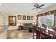 Open living room with hardwood floors, cozy furniture, and a dining area overlooking the outside balcony at 7630 Heritage Crossing Way # 302, Reunion, FL 34747