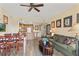 Open living area with hardwood style floors, sofa, dining table, and modern kitchen at 7630 Heritage Crossing Way # 302, Reunion, FL 34747
