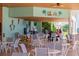 Inviting outdoor bar area with ample seating and tropical decor, ideal for social gatherings and casual dining at 7630 Heritage Crossing Way # 302, Reunion, FL 34747