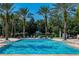 Beautiful pool area surrounded by lush tropical foliage and palm trees at 7630 Heritage Crossing Way # 302, Reunion, FL 34747