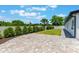The outdoor patio offers a spacious brick-paved area with trimmed hedges and ample room for entertaining at 7664 Clubhouse Estates Dr, Orlando, FL 32819