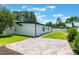 The expansive backyard shows a brick patio, complemented by lush plantings at 7664 Clubhouse Estates Dr, Orlando, FL 32819