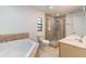Bathroom featuring a soaking tub, glass-enclosed shower, and double sink vanity at 7664 Clubhouse Estates Dr, Orlando, FL 32819