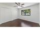 Bedroom featuring hardwood floors, ceiling fan, closet, and natural light at 7664 Clubhouse Estates Dr, Orlando, FL 32819