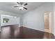 Spacious bedroom with hardwood floors, access to bathroom, and plenty of natural light at 7664 Clubhouse Estates Dr, Orlando, FL 32819