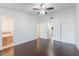 Large bedroom showing hardwood floors, ceiling fan, and attached bathroom and closet at 7664 Clubhouse Estates Dr, Orlando, FL 32819