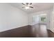 Spacious bedroom featuring hardwood floors, ceiling fan, and neutral walls at 7664 Clubhouse Estates Dr, Orlando, FL 32819