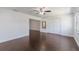 Bedroom featuring hardwood floors, ceiling fan, closet, and white trim and walls at 7664 Clubhouse Estates Dr, Orlando, FL 32819