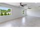 Bright bedroom with tile floors, two windows, and contemporary ceiling fans at 7664 Clubhouse Estates Dr, Orlando, FL 32819
