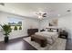 Bedroom with dark wood floors, a bench, and a bright window offering a beautiful yard view at 7664 Clubhouse Estates Dr, Orlando, FL 32819