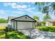 Exterior featuring a freshly painted home, an oversized garage and a driveway at 7664 Clubhouse Estates Dr, Orlando, FL 32819