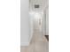 Hallway with tile floors, white walls, and multiple doorways leading to various rooms in the home at 7664 Clubhouse Estates Dr, Orlando, FL 32819