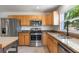 Updated kitchen features stainless steel appliances, granite countertops, and wood cabinets at 7664 Clubhouse Estates Dr, Orlando, FL 32819