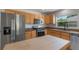 Modern kitchen features stainless steel appliances, granite counters, and light wood cabinets at 7664 Clubhouse Estates Dr, Orlando, FL 32819