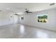 Bright living room with tile floors, ceiling fans, and windows offering natural light and exterior views at 7664 Clubhouse Estates Dr, Orlando, FL 32819