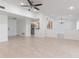 Open-concept living room with tile floors, lots of light and views of kitchen and dining areas at 7664 Clubhouse Estates Dr, Orlando, FL 32819