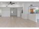 Bright open-concept living room with tile floors, ceiling fan, and clear view into the kitchen area at 7664 Clubhouse Estates Dr, Orlando, FL 32819