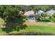 An aerial view of the back of a house with a screened-in pool and well-manicured lawn at 829 Lakeworth Cir, Lake Mary, FL 32746