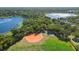 An aerial view showing a baseball field, lake, and park with lush greenery, and residential area at 829 Lakeworth Cir, Lake Mary, FL 32746