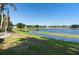 Serene backyard featuring a lush lawn and a tranquil lake, offering a peaceful outdoor escape at 829 Lakeworth Cir, Lake Mary, FL 32746