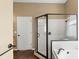 Bathroom features a shower with glass door and a soaking tub with tile surround at 829 Lakeworth Cir, Lake Mary, FL 32746