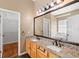 Primary bathroom featuring double sink vanity with granite counters and large mirror at 829 Lakeworth Cir, Lake Mary, FL 32746