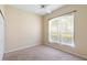 Bright bedroom featuring neutral walls, carpet flooring and natural light from the window at 829 Lakeworth Cir, Lake Mary, FL 32746