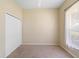Bright bedroom features neutral walls, carpet flooring, closet and natural light from the window at 829 Lakeworth Cir, Lake Mary, FL 32746