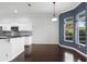 Dining area with a bay window, pendant lighting and dark wood flooring at 829 Lakeworth Cir, Lake Mary, FL 32746